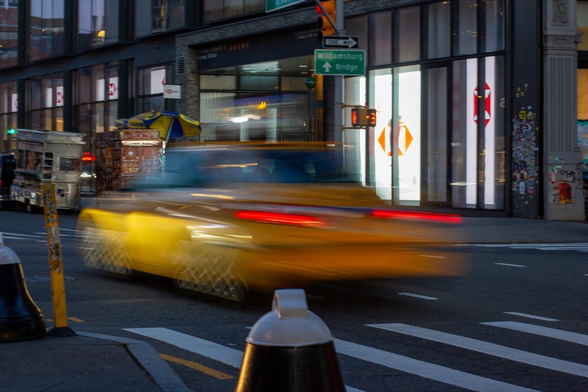 A yellow cab crossing a New York City intersection